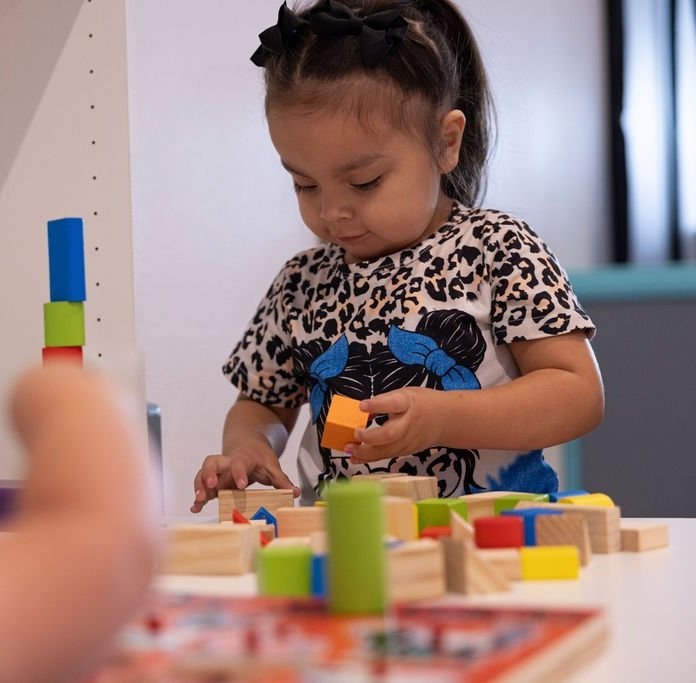 Child exploring colorful toys during a play activity